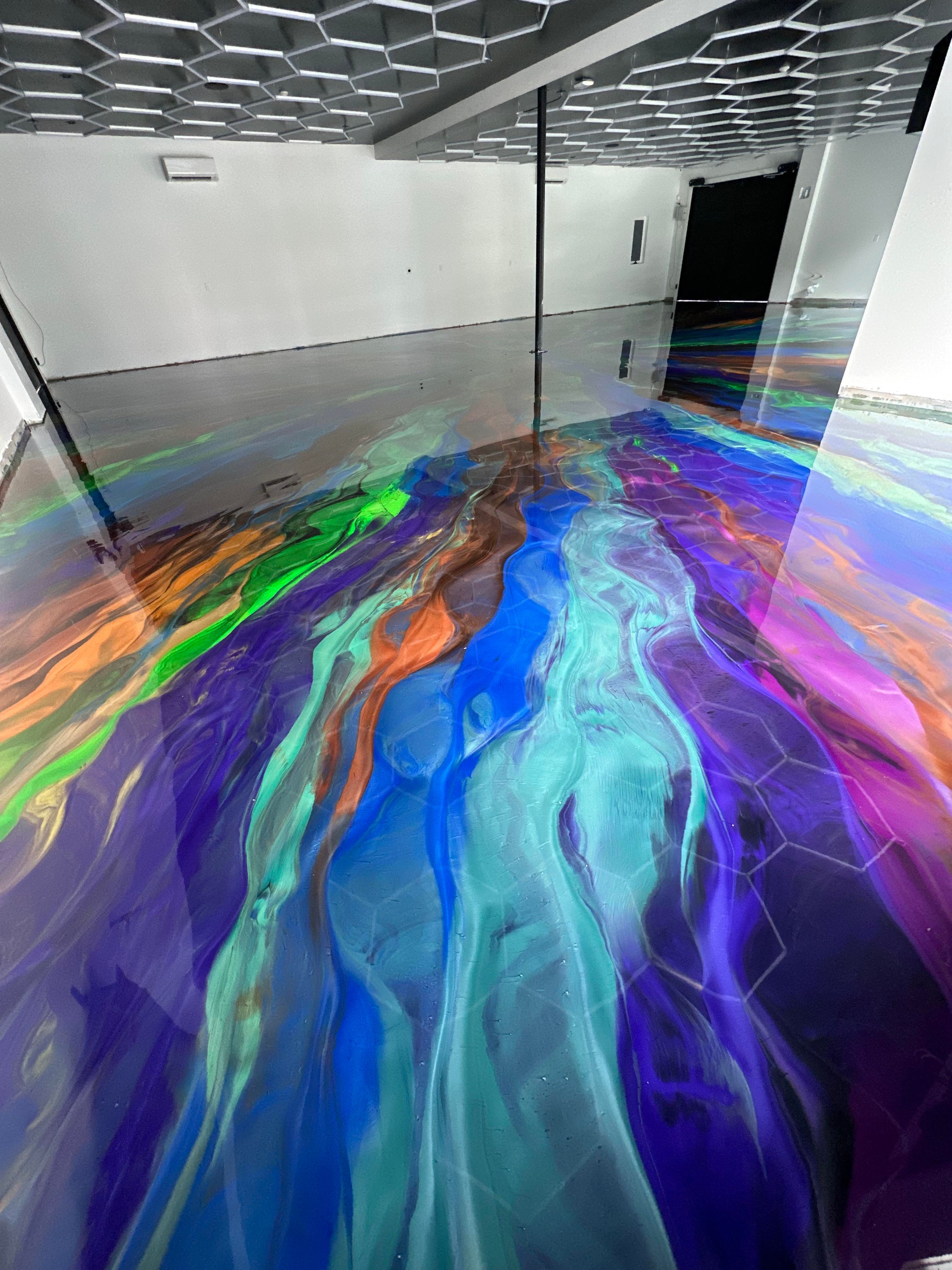 Metallic marble epoxy floor — flowing swirl patterns with depth and shine